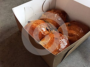 Raisin buns to go in cardboard box hot cross buns