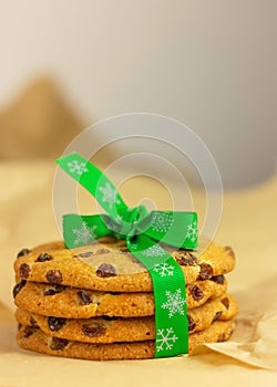 Raisin cookies tied with festive green christmas ribbon on wrapping paper