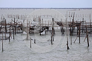 Raising fish in floating islands around Koh Yo Songkhla Lake Fisherman`s House at sunset at Songkhla Lake, Yo Island