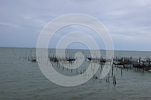 Raising fish in floating islands around Koh Yo Songkhla Lake Fisherman`s House at sunset at Songkhla Lake, Yo Island