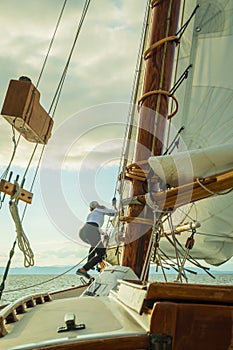 Raising the sail on a historic  gaff-rigged `Friendship` sloop