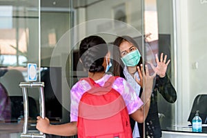 Raising their hand to greet student, Back to school