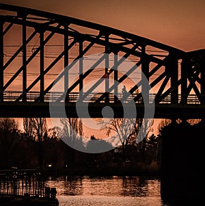 Raiway bridge, silhouette of steel construction, sunset view, Prague