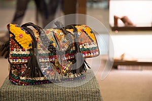Rajasthani Traditional Ladies Fancy Purse Placed on a stool in a store of New Delhi, India