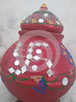 Rajasthani traditional mirror work art on pots.