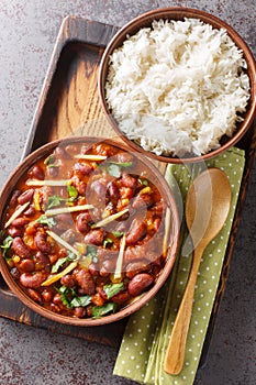 Rajma masala is a Indian vegetarian dish consisting of red kidney beans in a thick gravy with many spices served with rice close-