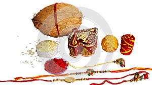 Indian brother and sister festival: Raksha Bandhan background with an elegant Rakhi, Rice Grains and Kumkum photo