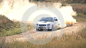 Rally Car Driving on a Dusty Road. Slow Motion