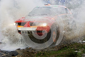 Rally car splashing water