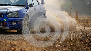 Rally racing car turning in curve on dirt track photo
