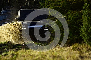 Rallying, competition and four wheel drive concept. Motor racing in autumn forest. Offroad race on fall nature