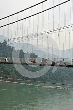 Ram Jhula hanging bridge, Rishikesh, India. The river Ganges