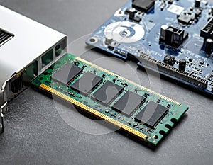 Wi-Fi card, RAM chip and computer motherboard in gray table, shutdown