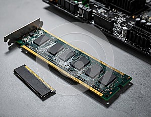 Wi-Fi card, RAM chip and computer motherboard in gray table, shutdown