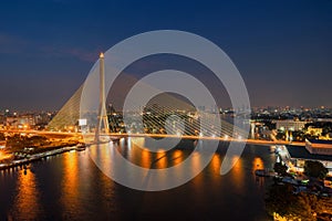 Rama 8 Bridge and Chao Phraya River in structure of suspension architecture concept, Urban city, Bangkok. Downtown area at night,
