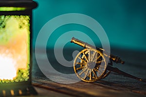 Ramadan Cannon with Colorful Light Glowing at Night and Glittering with Bokeh Lights on Ground. Festive Greeting Card, Invitation