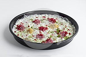 Ramadan Dessert Gullac in black metal tray on white surface