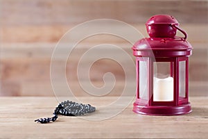 Ramadan Kareem / Eid Mubarak Electric Lamp and Prayer beads with wooden background