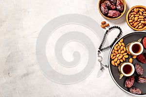 Ramadan Kareem greeting card. Table with dates fruits nuts and islamic rosary