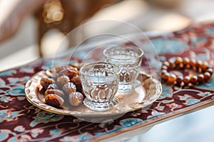 Ramadan Kareem holiday, water with dates fruit for Iftar