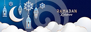 Ramadan Kareem horizontal banner with traditional lanterns, crescent, stars and clouds on dark blue night sky background