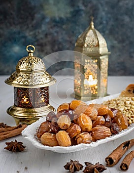 Ramadan Kareem and iftar muslim food. Holiday of Holy month of Ramadan. Dates, nuts, dried fruits and lattern with candles