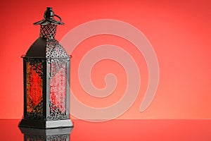 Ramadan lantern or Arabic decoration lamp on red background