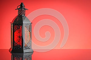 Ramadan lantern or Arabic decoration lamp on red background