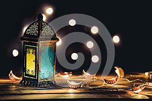 Ramadan Lantern with Colorful Light Glowing at Night and Glittering with Bokeh Lights on Ground. Festive Greeting Card, Invitation