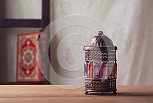 Ramadan lantern fanoos on a wooden table