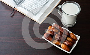 Ramadan moments dates and milk and coran iftar time photo