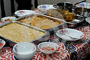 Ramadan month iftar table with different types of food, mashed potatoes stuffed with minced meat, pasta with bechamel sauce and photo