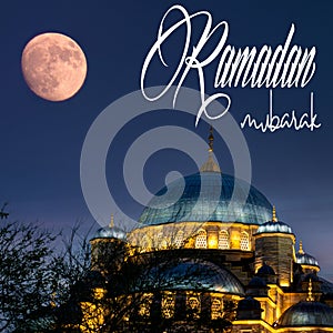 Ramadan mubarak or Ramazan Kareem. Full moon over Istanbul's New Mosque. Ramadan mubarak text in the image.