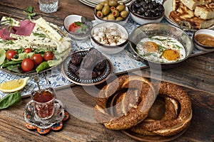 Ramadan Sahur include tomatoes, cucumbers, cheese, butter, eggs, honey, bread, bagels, olives and tea cups.