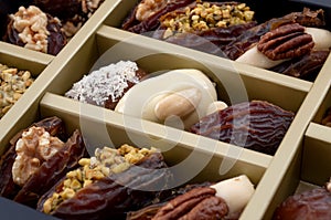 Ramadan sweets and luxurious selection of jumbo sweet dates concept with close up on medjool date stuffed with pistachio and