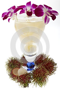 Rambutan with fruit juice and orchid