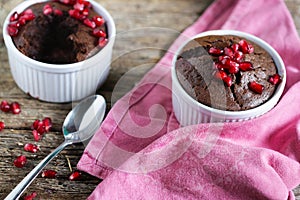 Ramekins with chocolate soft centre molten cake and pomgranate photo