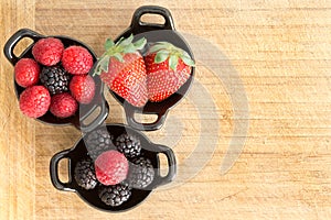 Ramekins of healthy ripe fresh mixed berries photo