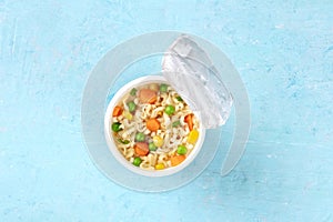 Ramen cup, instant noodles in a plastic cup, shot from above with a place for text