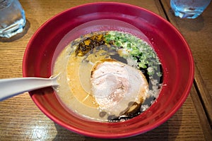 Ramen with pork in big red bowl