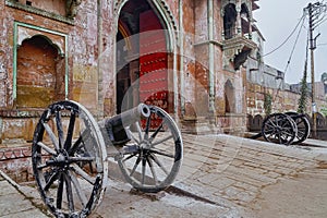 Old canons guarding the main gate to the historical Ramnagar Fort in Varanasi, India photo