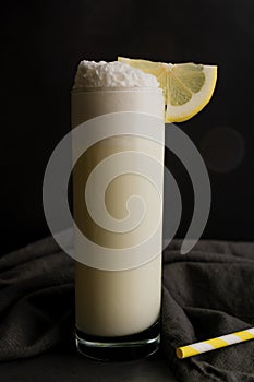 Ramos Gin Fizz Cocktail Garnished with Lemon