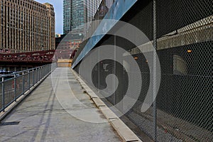 Ramp leading from Chicago riverwalk up to Upper Wacker Drive, with fence blocking access to Lower Wacker Drive.