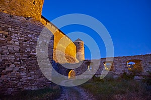 The ramparts of Kamianets-Podilskyi Castle in evening lights, Ukraine