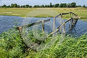 Ramshackle footbridge across a canal photo