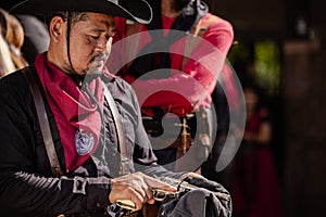 On the ranch, a cowboy prepares for a gunfight