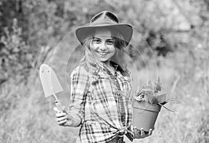 Ranch girl. Little kid hold flower pot. Spring country works. Happy childrens day. Happy childhood. Child in hat with