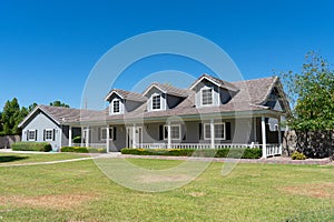 Ranch style home with porch and dormers