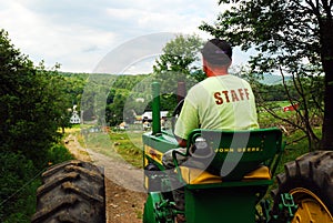 A ranch work drives his tractor on the farm