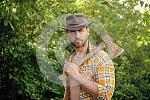 rancher with axe outdoor, copy space. photo of rancher with axe. rancher with axe.